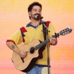 Camilo performing live on stage during a global tour