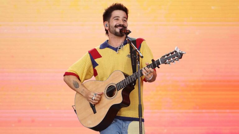 Camilo performing live on stage during a global tour