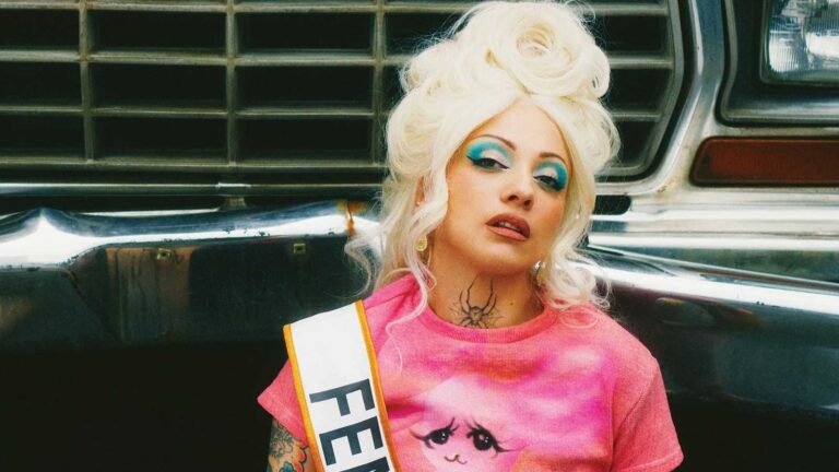 Mon Laferte posing in red during the Femme Fatale era promotional campaign