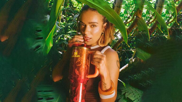 Karol G in the jungle with a Stanley