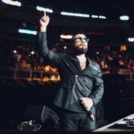 Alex Sensation on stage hosting Mega Mezcla live event