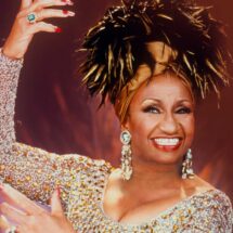 Celia Cruz performing live in iconic gold outfit during her career peak