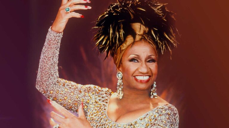 Celia Cruz performing live in iconic gold outfit during her career peak