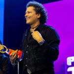 Carlos Vives accepting the Global Male Icon Award at Premios Tu Música Urbano Mix 2026.